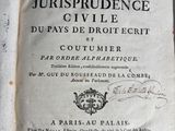 an old book with writing on it sitting on a table