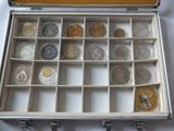 a silver case with coins inside of it on a table