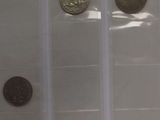 four different types of coins are in a clear plastic bag