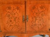 a wooden cabinet with a floral design on it