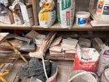 many buckets of paint on the shelves in the room