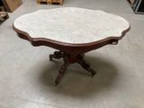a table with a marble top in a room
