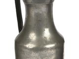 a silver pitcher with a bird on top of it