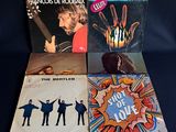 four vinyl records of the beatles, including the beatles ' s song of love, and the beatles ' s