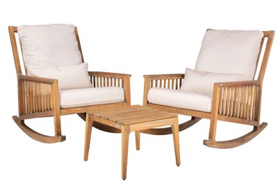 two wooden chairs and a table with a white cushion