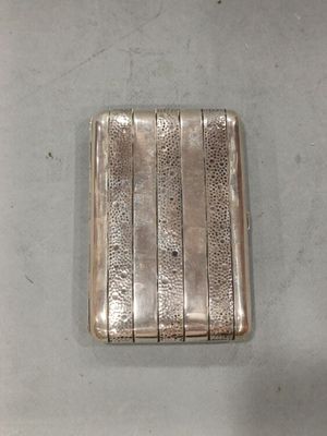 an old silver cigarette case sitting on top of a table