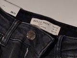 the back of a pair of black jeans with a tag on it