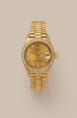 a lady ' s rolex watch with yellow dial and diamonds