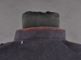 a close up of a black jacket with a red stripe on the collar