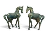 pair of bronze horse figurines on a white background