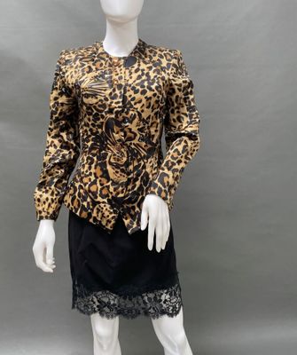 a mannequin wearing a leopard print top and black skirt