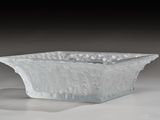 a glass bowl that is sitting on a table
