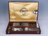 silverware in a wooden case with a gold lining