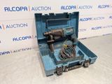 a blue tool box with a drill in it sitting on a table