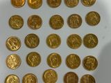 a lot of gold coins that are on the table