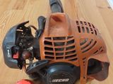 a close up of a lawn mower on a wooden table