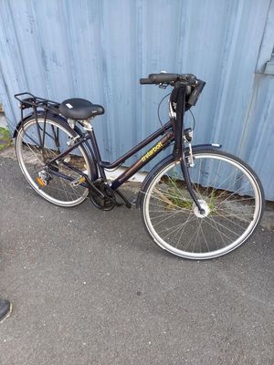 a bike that is parked next to a blue wall