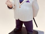 a figurine of a man in a suit on top of a box