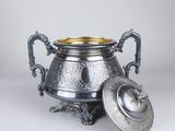 an antique silver plated urn with a lid on a stand