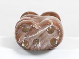 a wooden heart shaped object on a white surface