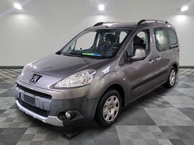 the small grey van is parked in the garage on a checkered floor