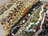 many different types of beaded bracelets on a table