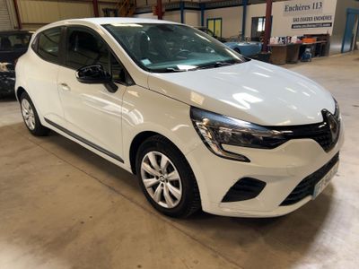 a white car parked in a garage with other cars in the background