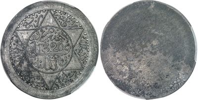 a close up of a silver coin with a star on it