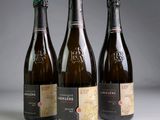 three bottles of wine sitting next to each other on a table
