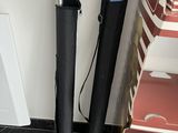 a black umbrella that is next to a pair of black shoes