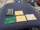 a blue car with a lot of books on top of it