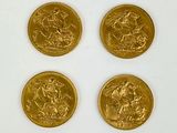 four gold sovereigns of different sizes and shapes on a white surface