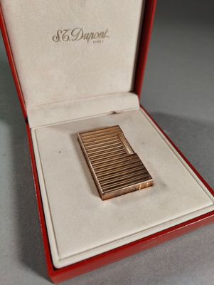 a small gold cigarette case in a red box