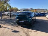 many cars parked in a parking lot with people walking by