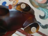 a hand holding a bottle of wine that is shaped like a dog