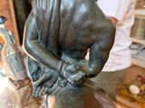 statue of a man sitting on a horse in a shop