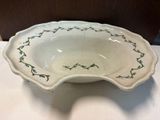 a white bowl with blue flowers on it on a table