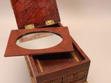 a small wooden box with a mirror in it
