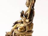an image of a statue of a person sitting on a chair