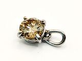a close up of a diamond pendant on a white surface