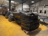 a large pile of black plastic bags in a warehouse