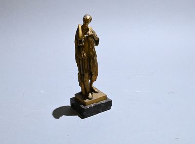 a small statue of a man standing on a marble base