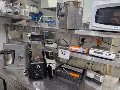 a kitchen with a microwave, blender, and other appliances on the counter