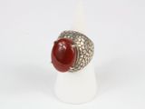 silver ring with a red stone in the middle of it