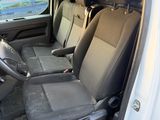 the interior of a car with the door open and the passenger seat down