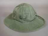 a green hat that is sitting on a table