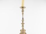 a silver candle holder with a candle on top of it