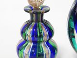 two glass vases sitting next to each other on a white surface
