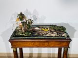 a small table with a plant on top of it