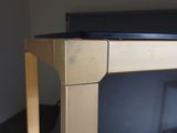 a wooden table with a laptop on top of it